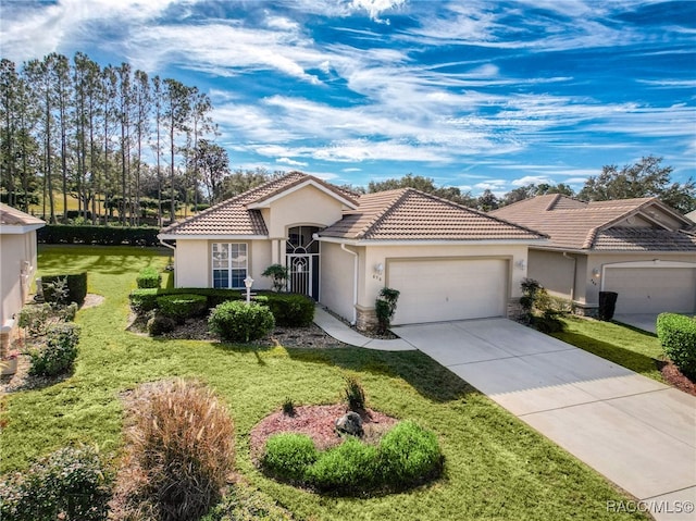 mediterranean / spanish-style home with a garage and a front lawn