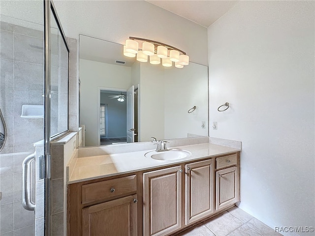 bathroom featuring walk in shower, vanity, and tile patterned flooring