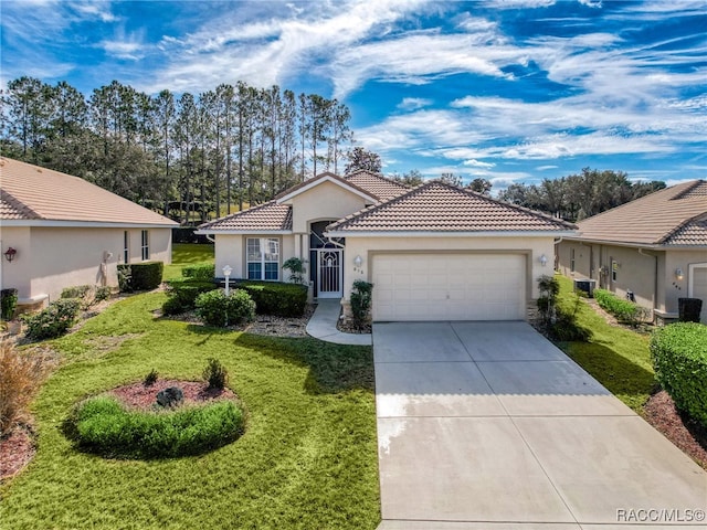 view of front of home with a garage and a front yard