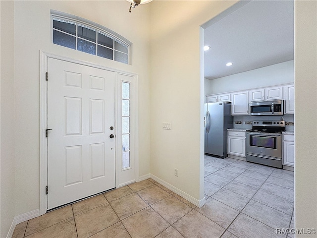 foyer entrance featuring light tile patterned floors