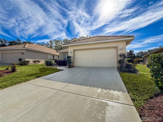 view of front of home with a garage and a front lawn