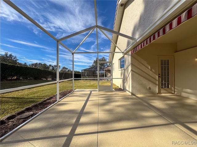 view of patio with glass enclosure