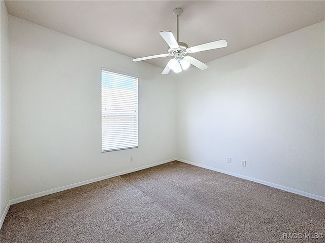 carpeted empty room featuring ceiling fan