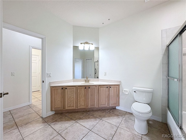 full bathroom with bath / shower combo with glass door, tile patterned flooring, vanity, toilet, and a textured ceiling