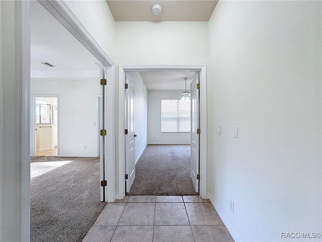 hallway with light carpet