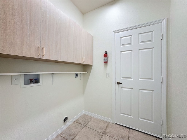 laundry area with cabinets, hookup for an electric dryer, hookup for a washing machine, and light tile patterned floors