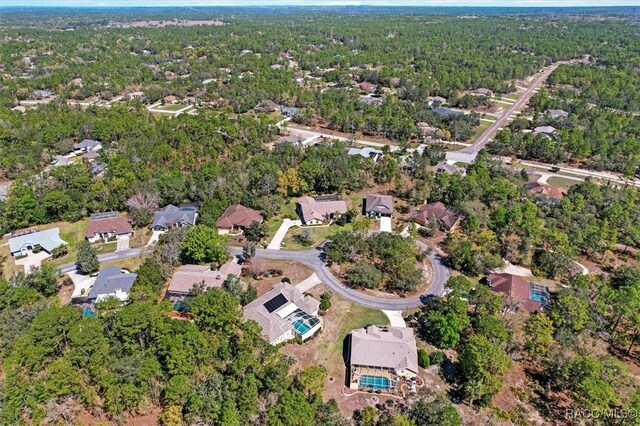 aerial view featuring a wooded view and a residential view