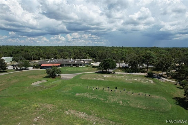 view of property's community with golf course view and a forest view