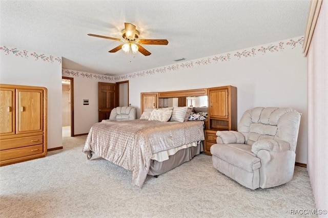 bedroom with visible vents, light carpet, a ceiling fan, a textured ceiling, and baseboards