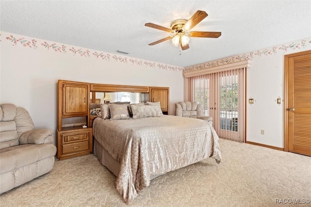 bedroom with baseboards, light colored carpet, a textured ceiling, a ceiling fan, and access to outside