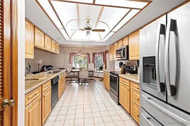 kitchen with light tile patterned floors, a ceiling fan, light brown cabinets, a sink, and stainless steel appliances