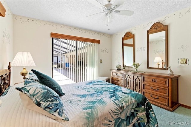 carpeted bedroom featuring ceiling fan, access to exterior, and a textured ceiling