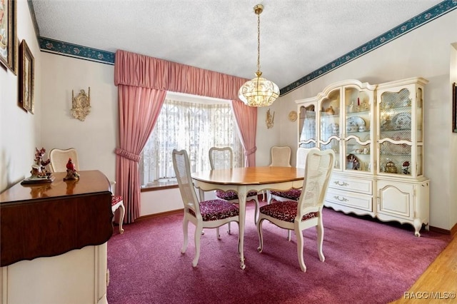 dining area featuring a notable chandelier, baseboards, and a textured ceiling