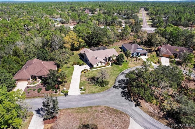 birds eye view of property featuring a view of trees