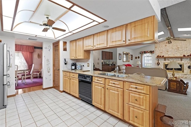 kitchen with dishwasher, a skylight, a ceiling fan, and a sink