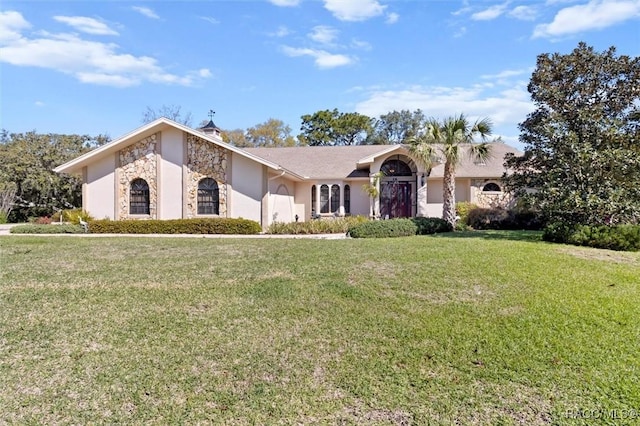 view of front facade featuring stone siding and a front lawn