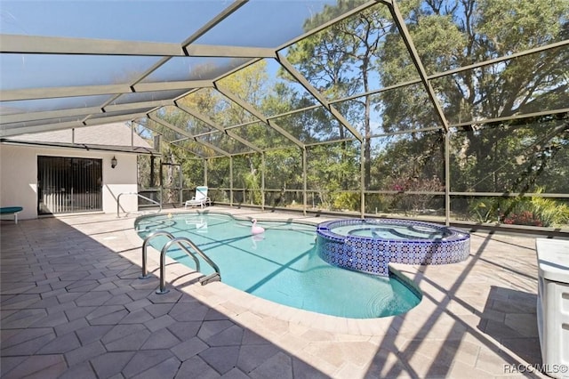 view of pool with a patio, a lanai, and a pool with connected hot tub