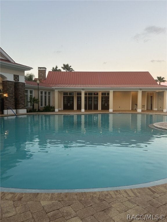 view of pool at dusk