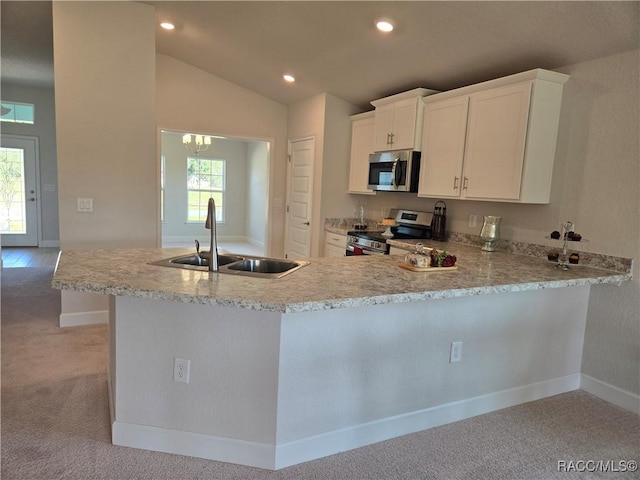1280 Heron Point Dr, Inverness, FL 34453 - kitchen featuring light countertops, light colored carpet, stainless steel appliances, and a sink
