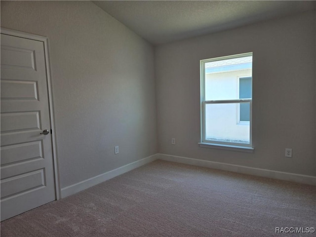 1280 Heron Point Dr, Inverness, FL 34453 - empty room featuring baseboards and light colored carpet