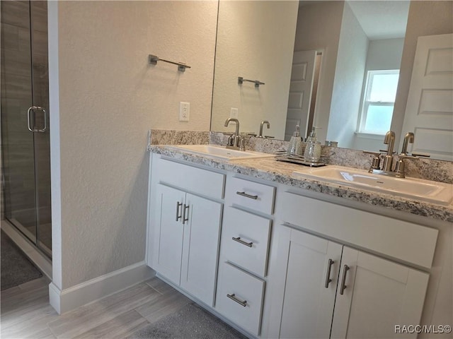 1280 Heron Point Dr, Inverness, FL 34453 - full bath with a textured wall, wood finished floors, a sink, and a stall shower