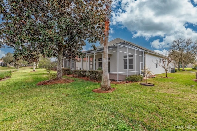 1095 W Skyview Landings Dr, Hernando, FL 34442 - view of home's exterior with a lanai, central AC unit, a yard, and stucco siding