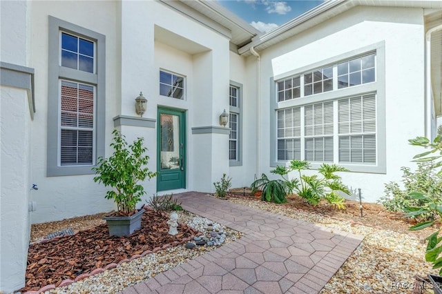 doorway to property with stucco siding