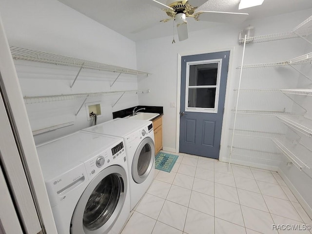 washroom featuring cabinets, ceiling fan, sink, light tile patterned floors, and washing machine and dryer