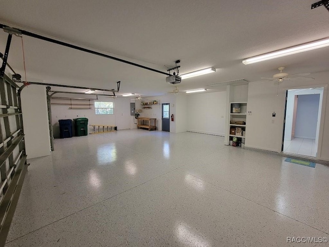 garage with a garage door opener and ceiling fan