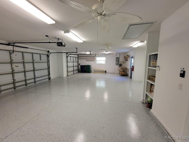 garage featuring electric panel, ceiling fan, and a garage door opener