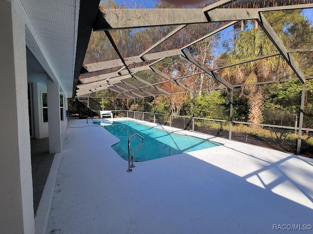 view of pool featuring glass enclosure and a patio