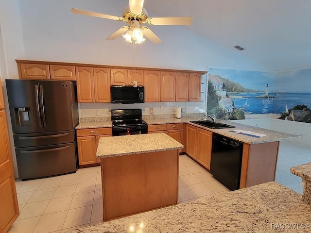 kitchen featuring sink, a kitchen island, vaulted ceiling, light tile patterned flooring, and black appliances