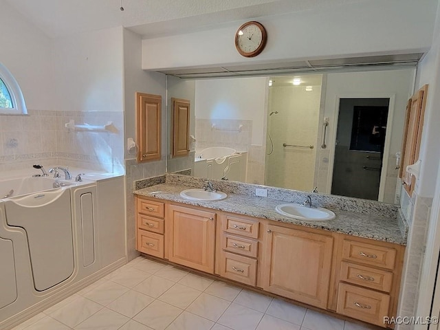 bathroom featuring tile patterned floors, vanity, and separate shower and tub