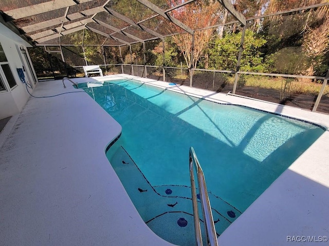 view of swimming pool with glass enclosure