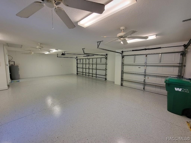 garage with ceiling fan, electric water heater, and a garage door opener