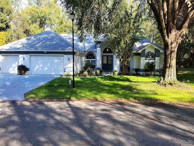 ranch-style house with a front yard and a garage