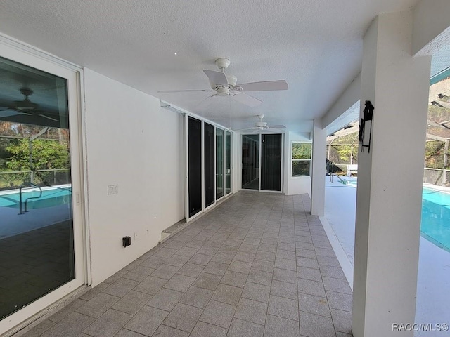 view of patio with a fenced in pool and ceiling fan