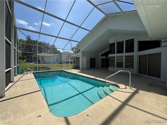 outdoor pool featuring a lanai, a patio, and ceiling fan