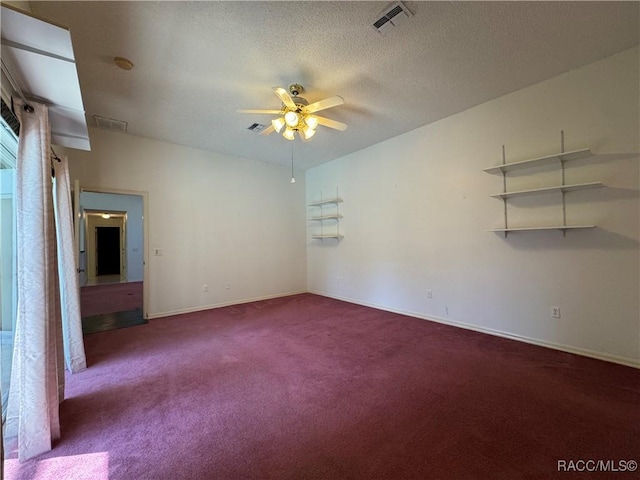carpeted empty room featuring visible vents, baseboards, and ceiling fan