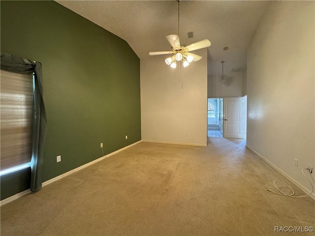 unfurnished room featuring baseboards, ceiling fan, light carpet, and high vaulted ceiling