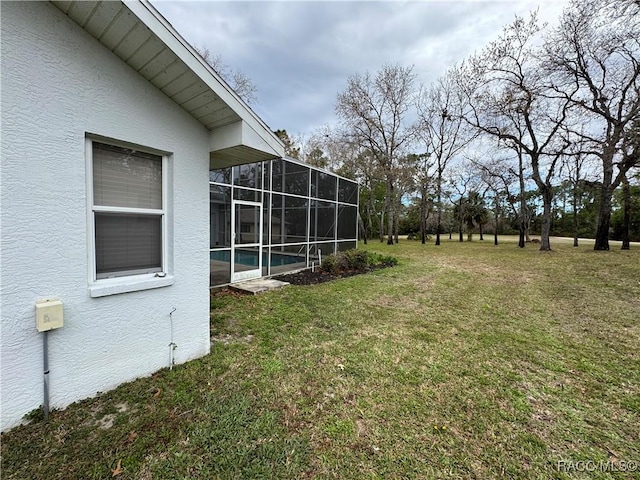 view of yard featuring glass enclosure and a pool