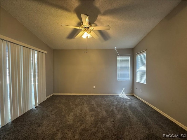 unfurnished room featuring baseboards, carpet, a ceiling fan, and a textured ceiling