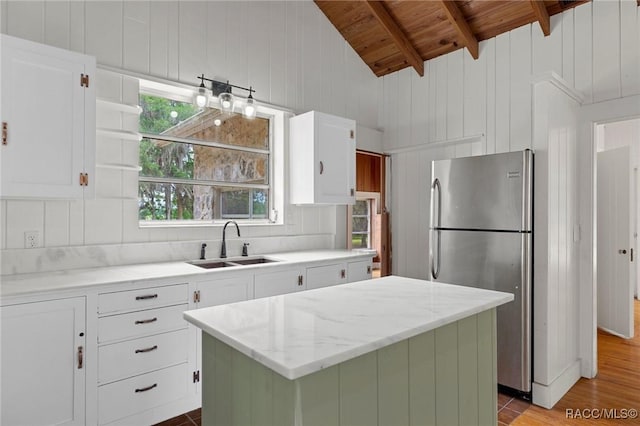 3184 N Edward Island Pt, Hernando, FL 34442 - kitchen featuring freestanding refrigerator, a sink, wood ceiling, a center island, and white cabinetry