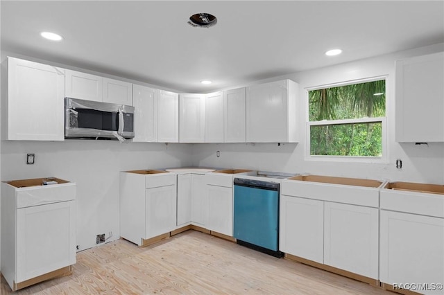 3184 N Edward Island Pt, Hernando, FL 34442 - kitchen featuring stainless steel microwave, dishwasher, light wood-type flooring, white cabinetry, and recessed lighting