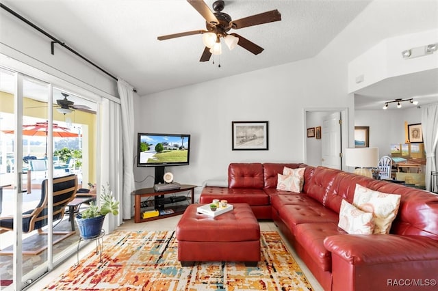 living room with a textured ceiling and vaulted ceiling