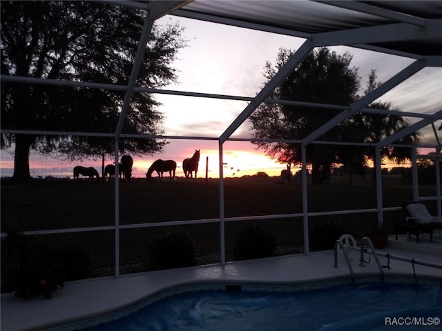 pool at dusk with glass enclosure