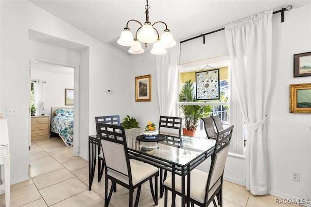 dining space featuring a chandelier, lofted ceiling, a healthy amount of sunlight, and light tile patterned flooring