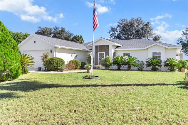 ranch-style home with a front yard and a garage