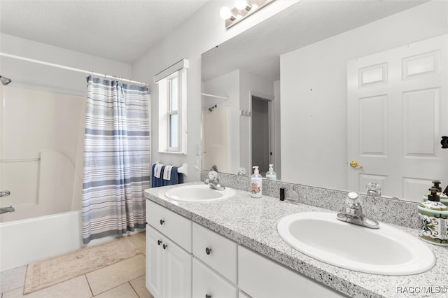 bathroom with tile patterned floors, a textured ceiling, vanity, and shower / tub combo