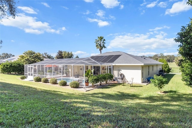 back of property featuring a lawn, solar panels, and a lanai